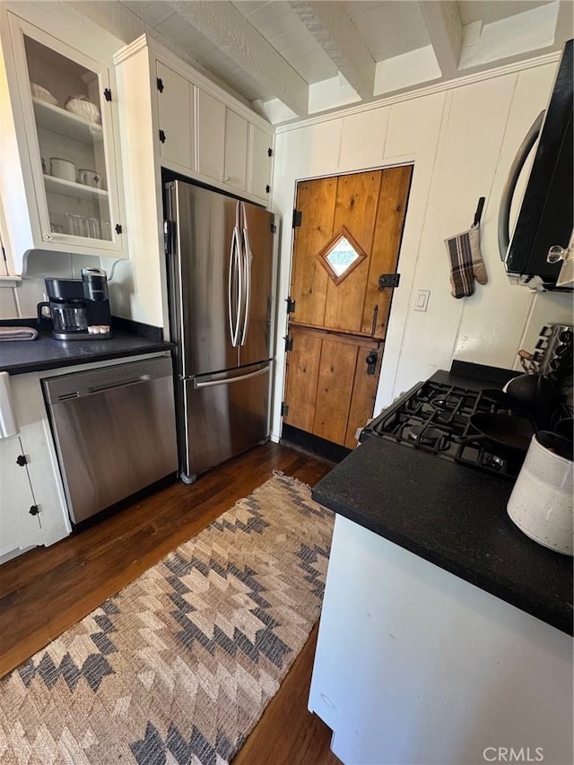 283 Walnut Dr, Lake Arrowhead, CA 92352 - kitchen with stainless steel appliances, dark wood-style flooring, dark countertops, and beamed ceiling