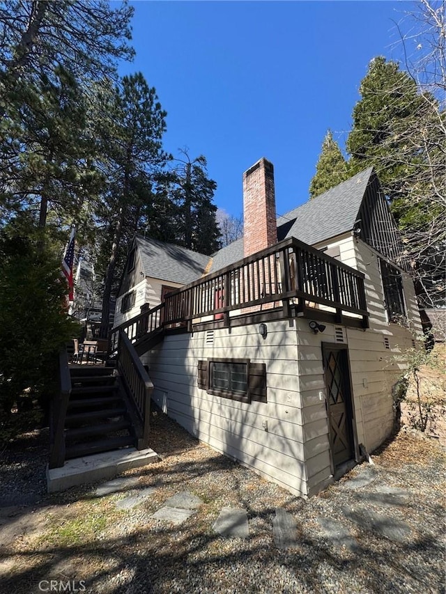 283 Walnut Dr, Lake Arrowhead, CA 92352 - view of side of home with a chimney, a shingled roof, stairs, and a deck