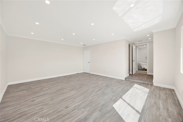 unfurnished room featuring recessed lighting, baseboards, crown molding, and light wood finished floors