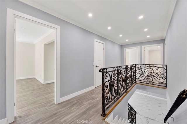 corridor featuring crown molding, recessed lighting, light wood-style floors, an upstairs landing, and baseboards