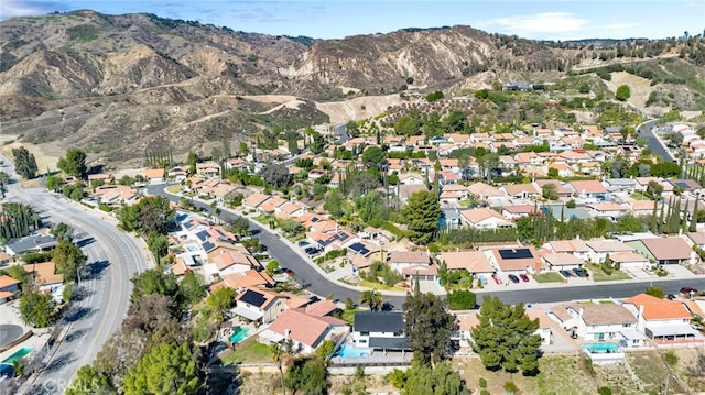 drone / aerial view featuring a residential view and a mountain view