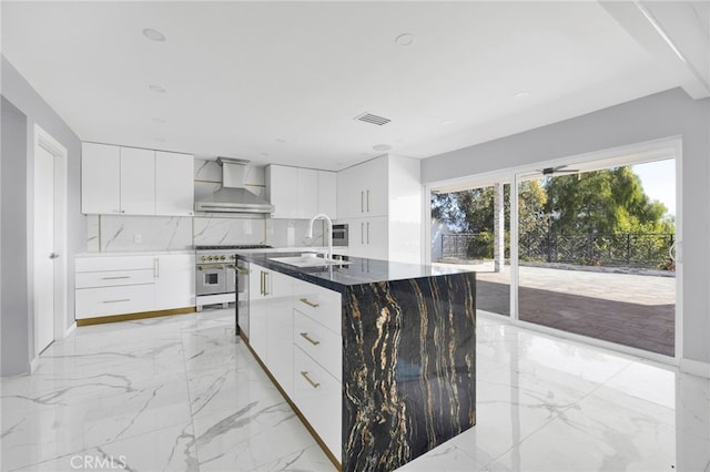 kitchen featuring wall chimney exhaust hood, modern cabinets, high end stainless steel range, marble finish floor, and a sink