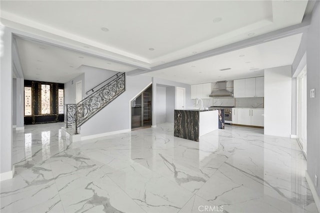 kitchen featuring white cabinets, wall chimney exhaust hood, modern cabinets, open floor plan, and high end stainless steel range oven