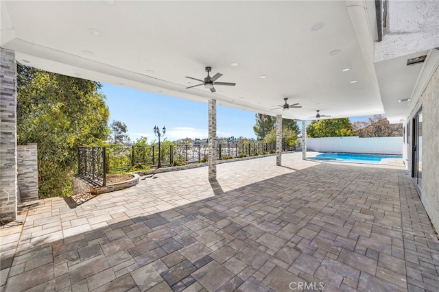 view of patio / terrace with a ceiling fan, a fenced in pool, and a fenced backyard