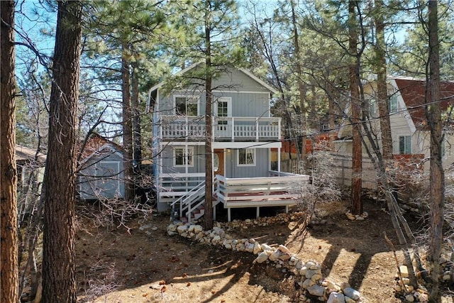 back of property featuring a wooden deck