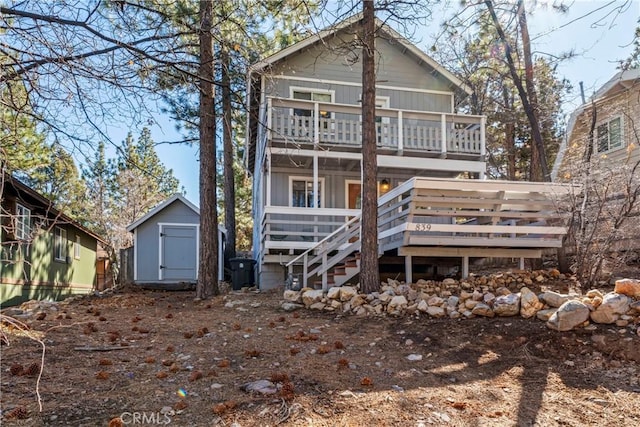 back of house featuring an outbuilding and a storage shed