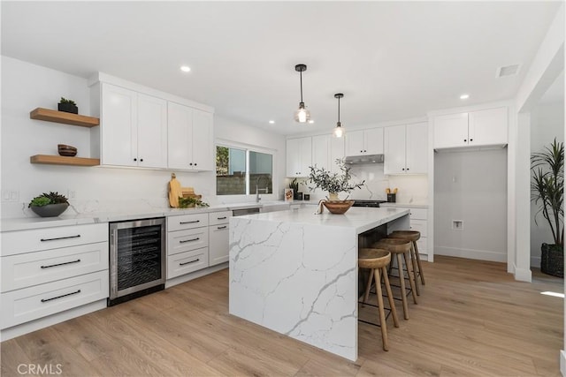 kitchen with open shelves, wine cooler, light wood-type flooring, and white cabinetry