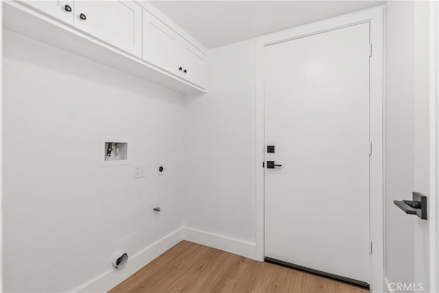 clothes washing area with cabinet space, baseboards, hookup for a washing machine, light wood-style floors, and electric dryer hookup