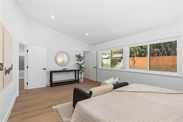 bedroom featuring vaulted ceiling, recessed lighting, baseboards, and light wood-style floors