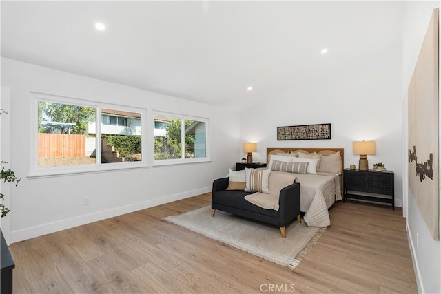 bedroom with recessed lighting, baseboards, vaulted ceiling, and light wood finished floors