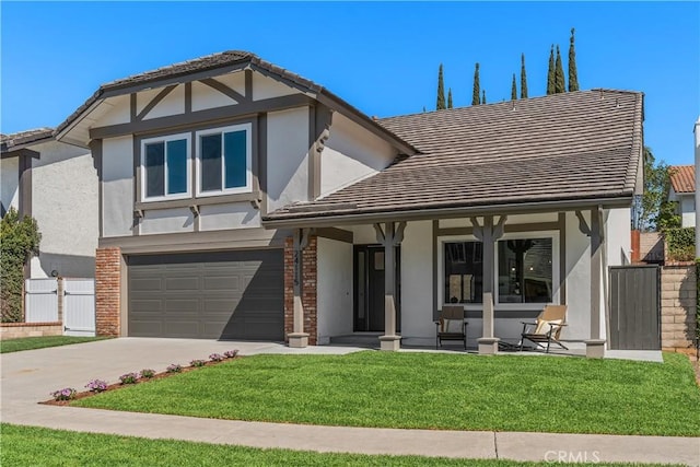 english style home featuring brick siding, stucco siding, concrete driveway, a front yard, and a garage