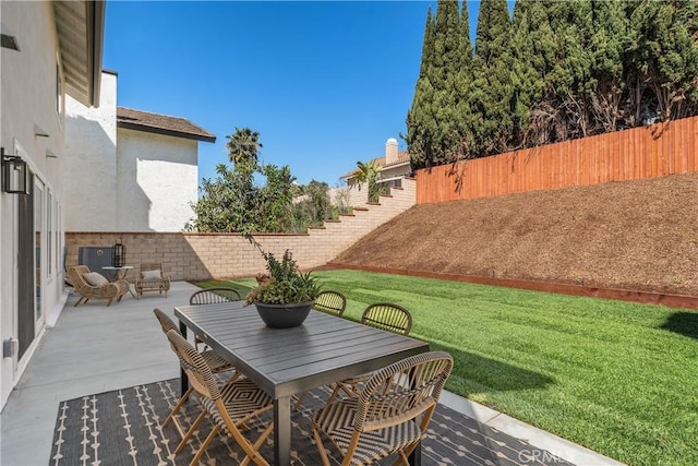 view of patio featuring outdoor dining area and a fenced backyard