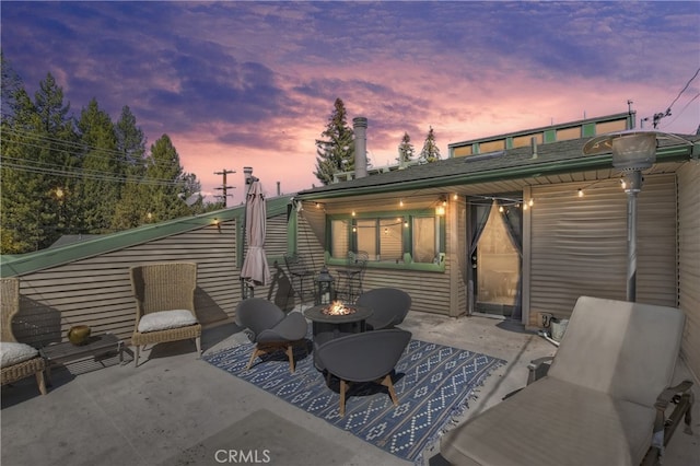 patio terrace at dusk with an outdoor fire pit