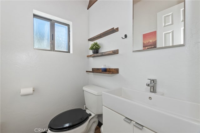 half bath with vanity and toilet