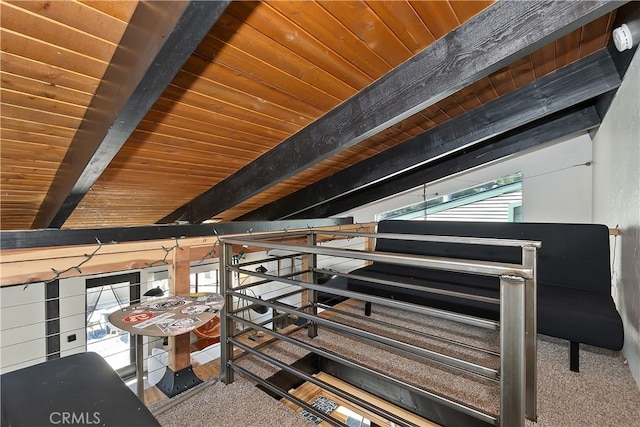 interior space with carpet floors, wood ceiling, and beam ceiling