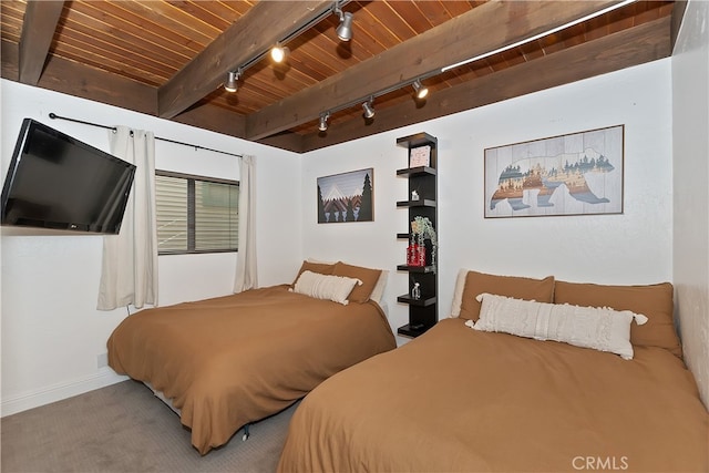 bedroom featuring wood ceiling, rail lighting, and beamed ceiling