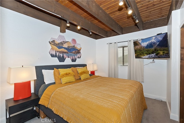 bedroom with baseboards, beam ceiling, wood ceiling, and track lighting