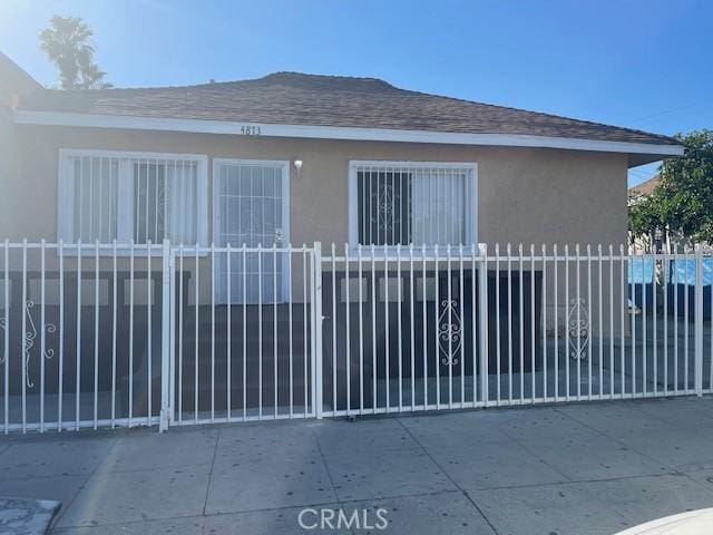 view of gate with a fenced front yard