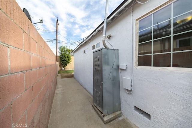 view of home's exterior featuring fence and stucco siding