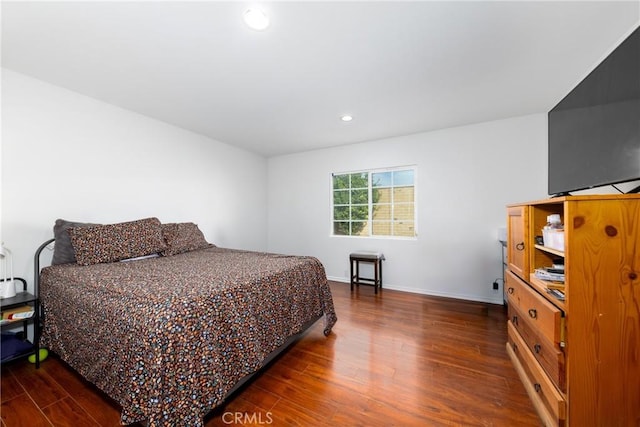 bedroom featuring baseboards, dark wood-type flooring, and recessed lighting