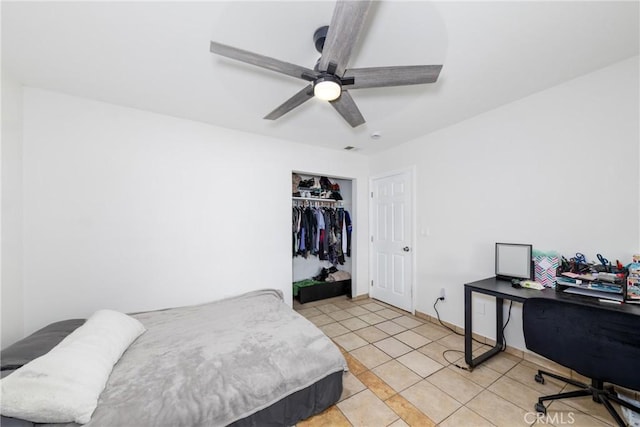 bedroom featuring light tile patterned floors, a ceiling fan, and a closet