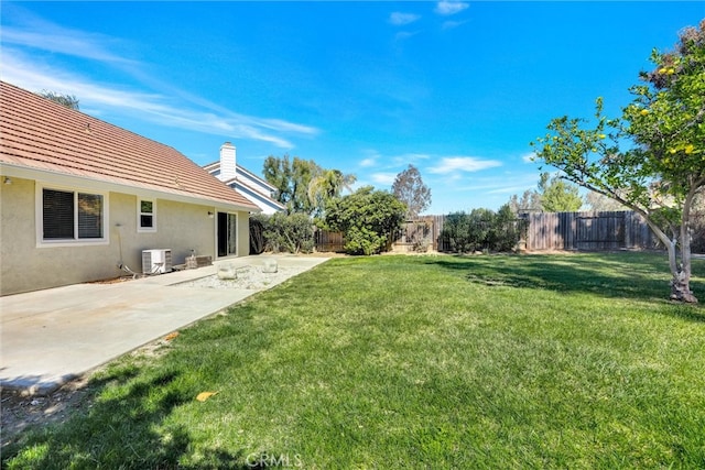 view of yard featuring a fenced backyard, cooling unit, and a patio