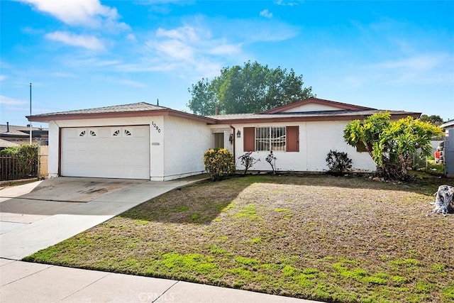 single story home with a garage, fence, concrete driveway, stucco siding, and a front yard