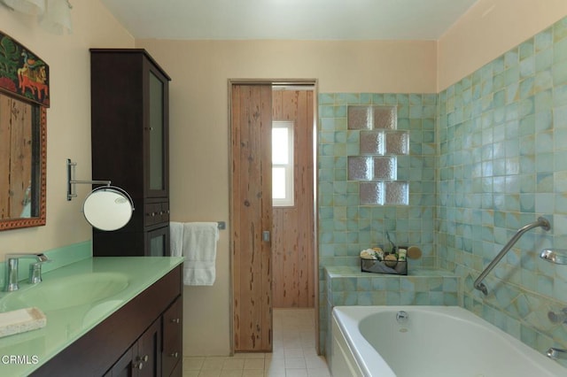 full bath featuring vanity, a bath, and tile patterned floors