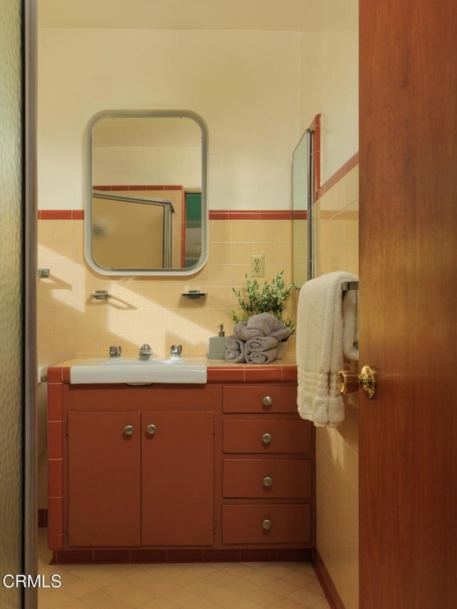 bathroom featuring tile walls and vanity