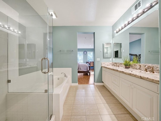 bathroom with double vanity, visible vents, connected bathroom, a garden tub, and tile patterned flooring