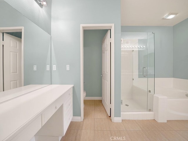 full bath featuring toilet, baseboards, a shower stall, a bath, and tile patterned floors