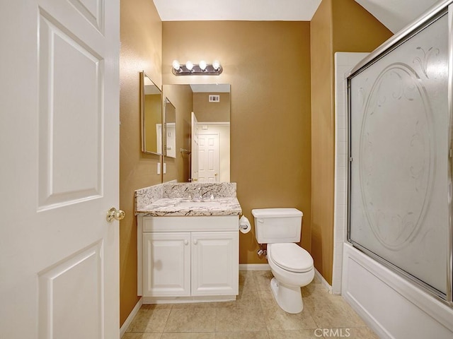 bathroom featuring baseboards, toilet, tile patterned floors, combined bath / shower with glass door, and vanity