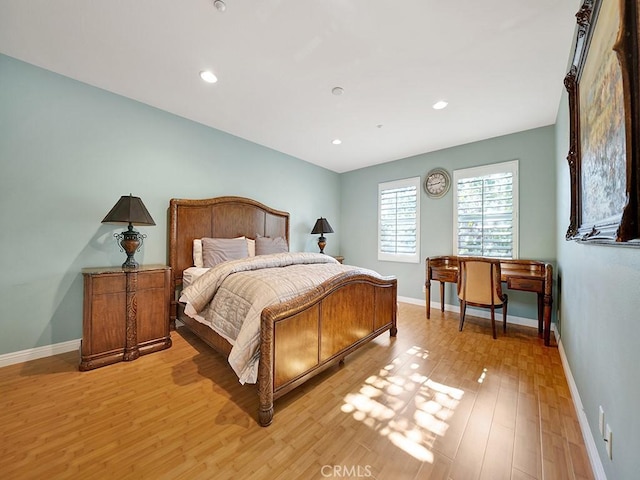 bedroom with recessed lighting, light wood-type flooring, and baseboards