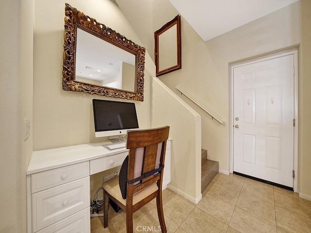 office featuring built in study area, baseboards, and light tile patterned floors