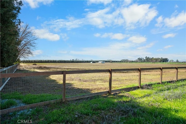 view of yard featuring a rural view and fence