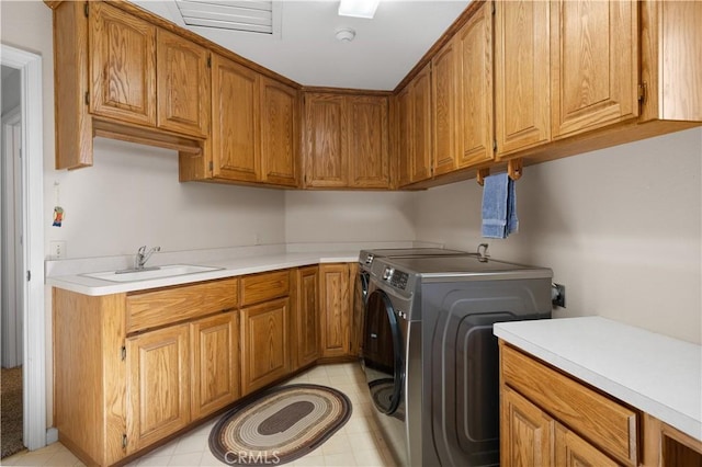 laundry room featuring a sink, cabinet space, and washer and clothes dryer