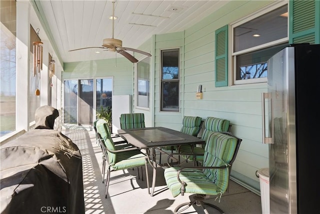 sunroom with ceiling fan and wooden ceiling