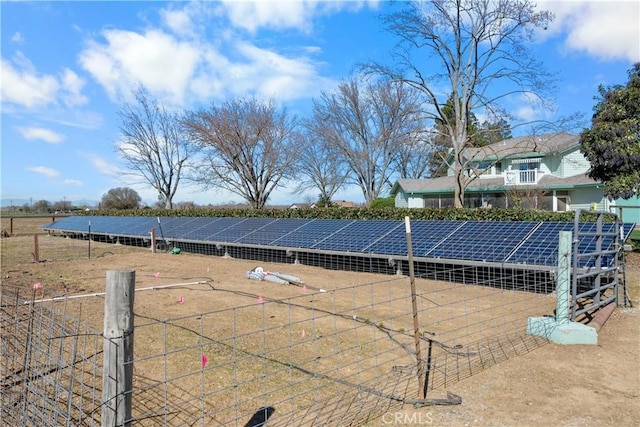 view of tennis court with an outbuilding