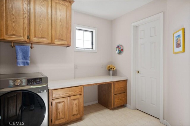 laundry area featuring washer / clothes dryer and cabinet space