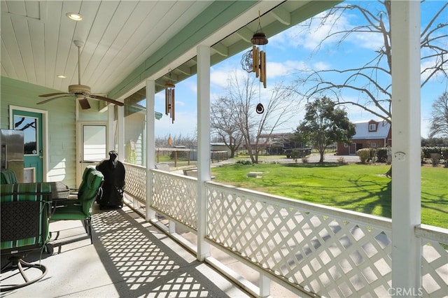 balcony featuring a porch and ceiling fan