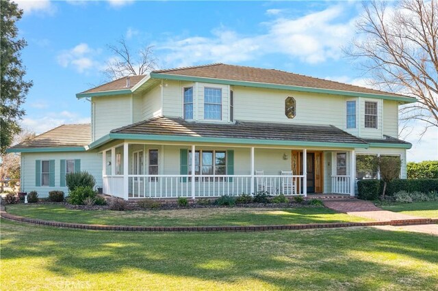 view of front facade featuring covered porch and a front yard