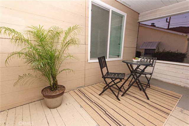 wooden terrace with outdoor dining area