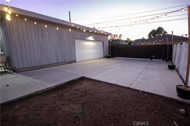 detached garage featuring fence