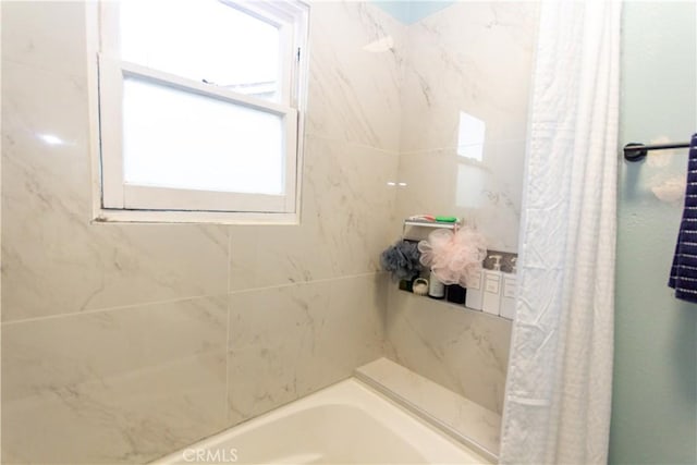 bathroom with a bathtub and a shower with shower curtain