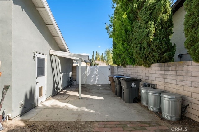 view of patio featuring a gate and fence