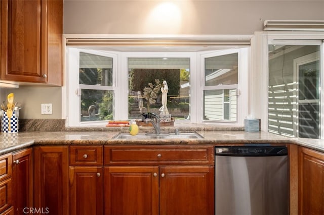 kitchen with dishwasher, a sink, and brown cabinets