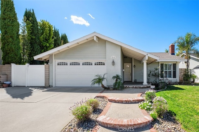 view of front of property featuring a garage, concrete driveway, a front yard, and fence