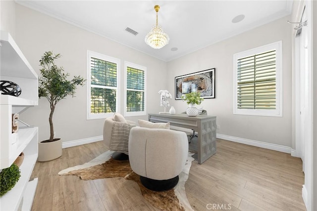 dining space with light wood finished floors, baseboards, visible vents, crown molding, and a notable chandelier