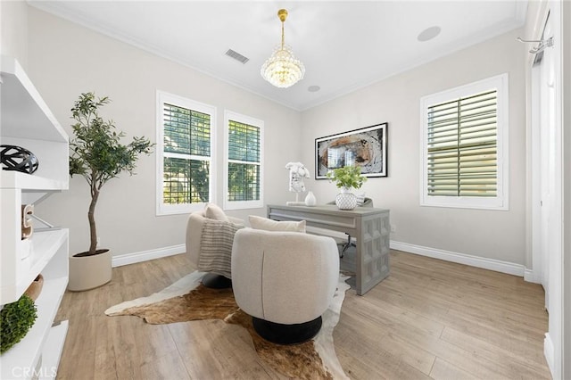 office featuring light wood finished floors, an inviting chandelier, visible vents, crown molding, and baseboards