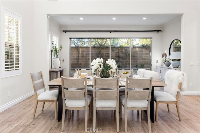 dining area with plenty of natural light, baseboards, and wood finished floors